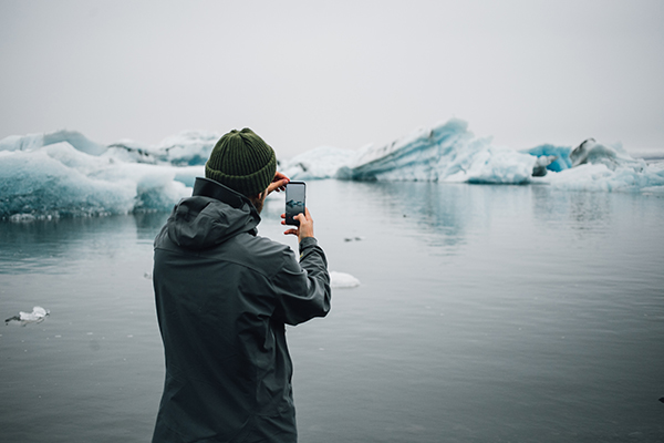 Traveler or tourist makes photos of icebergs